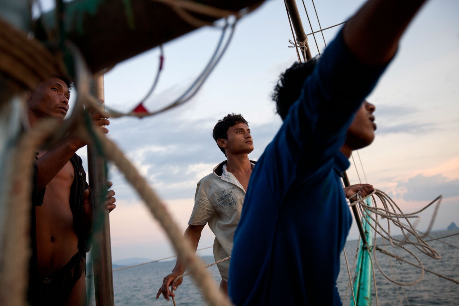 EMPTYING THE SEAS - Burmese fishermen set off for a night on a Thai fishing...