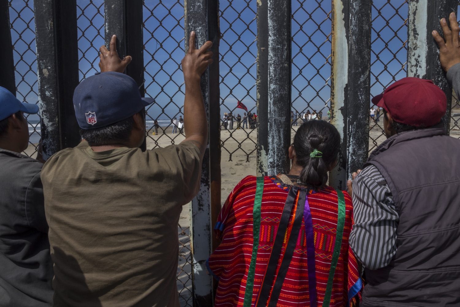 Farmworkers from Mexico&rsquo;s San Quintin valley gather&nbsp;at the border fence to...