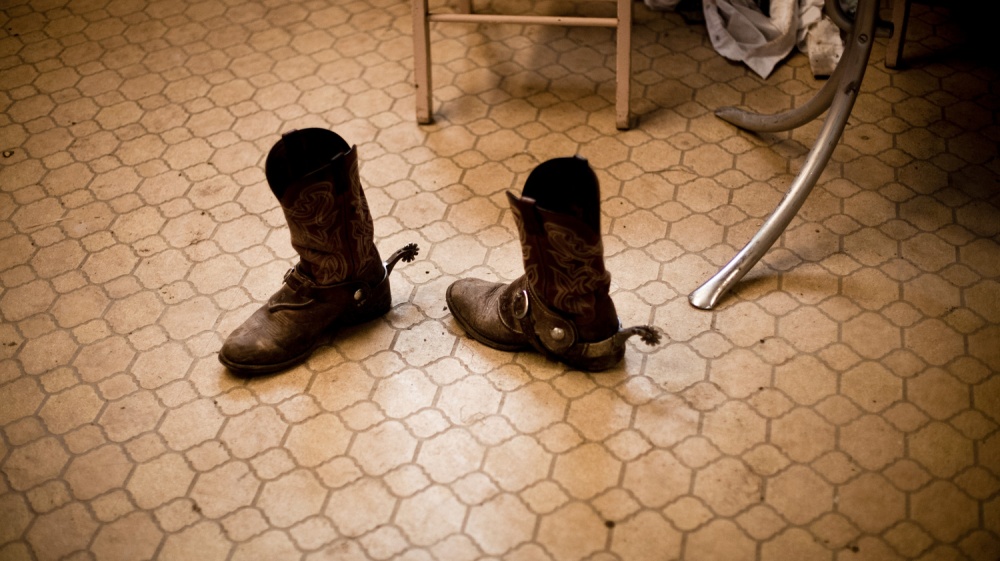 Cowboy boots at the feedyard office. Millions of cows are gaining weight in feedyards across the...