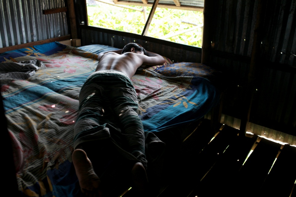 A truck driver sleeps in one of...he drive to the capital, Dhaka.