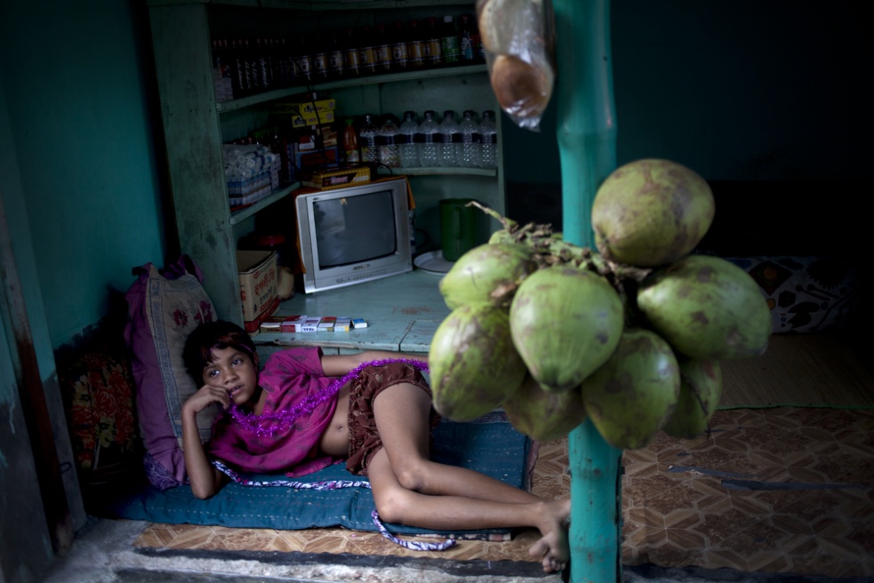 A child relaxes in a corner sho...itution by the age of 12 or 13.