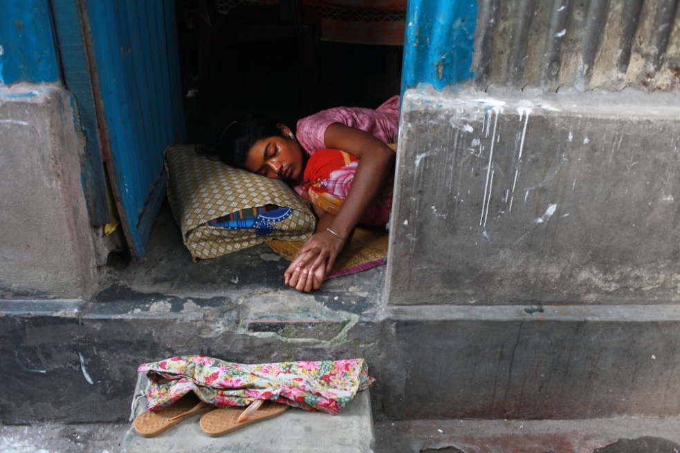 A sex worker taking a nap in he...n the banks of the Padma River.
