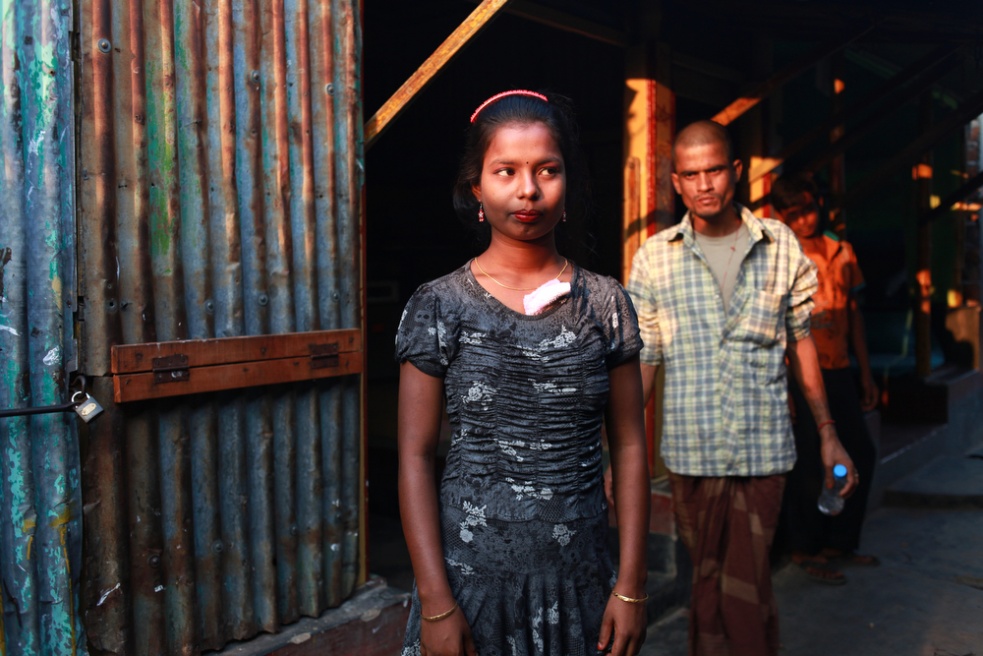 A customer approaches an undera...n the banks of the Padma River.
