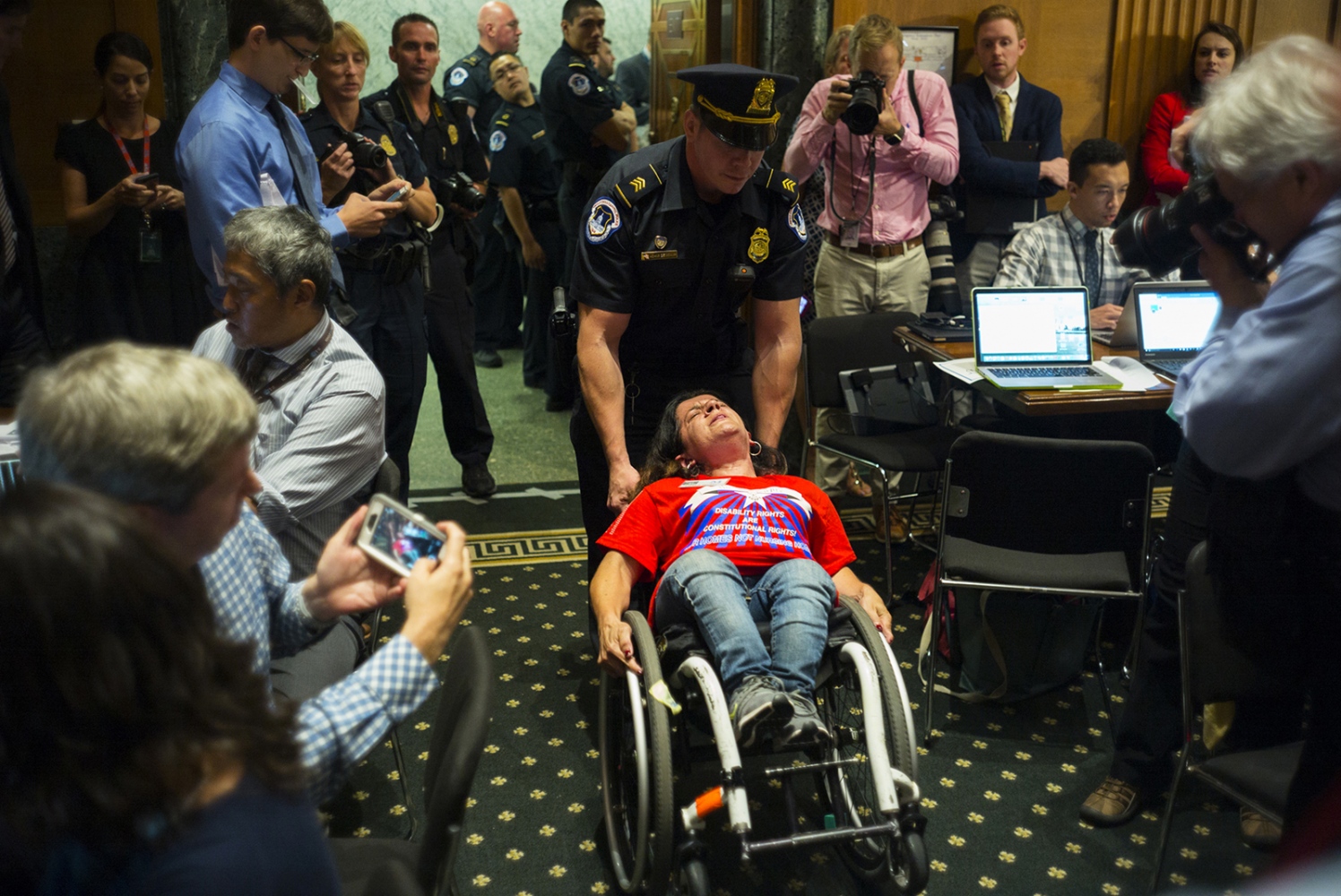 Politics -  A protester is removed from a Senate Finance Committee...