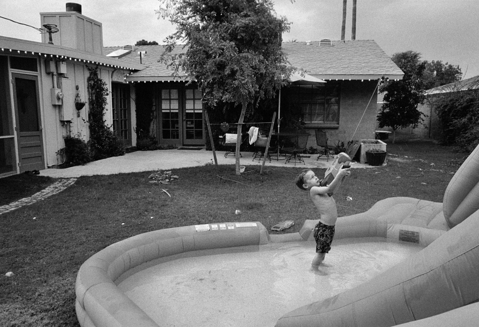 Death of The Colorado - A child plays alone in his suburban backyard near...