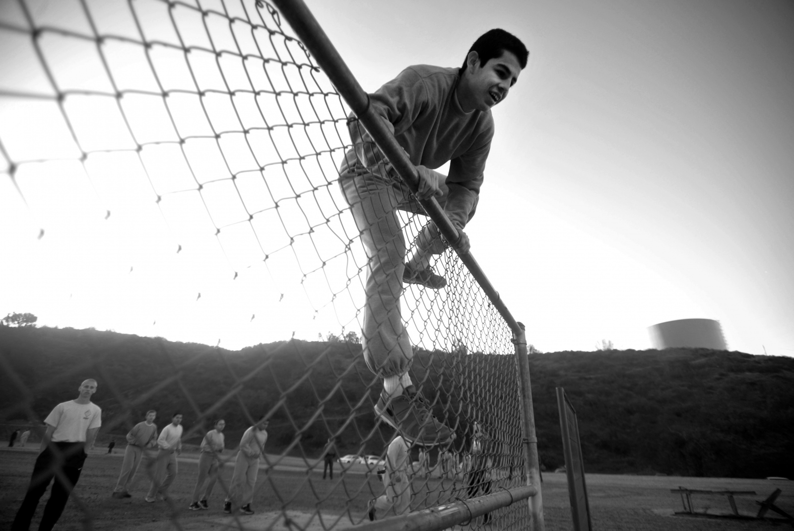 An Explorer recruit jumps over a fence during physical training at Pitchess Detention Center on...