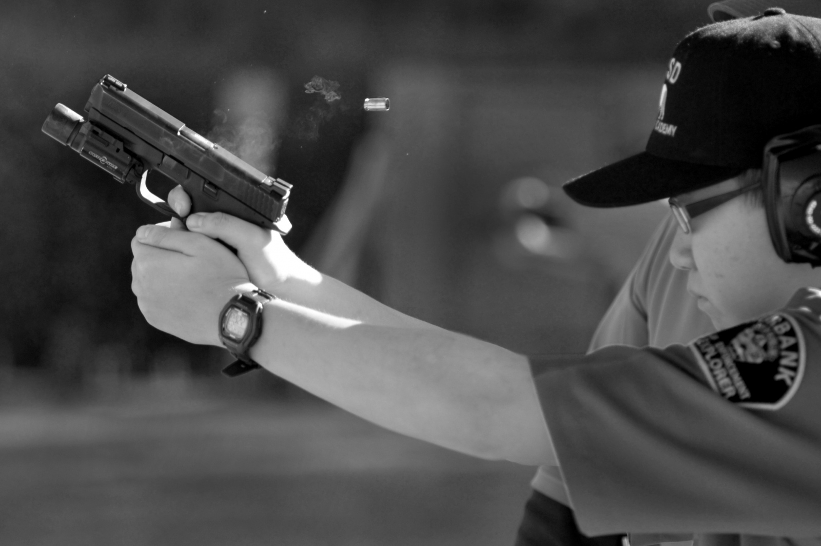 A recruit fires a 9mm handgun under supervision of a deputy sheriff at the shooting range at...