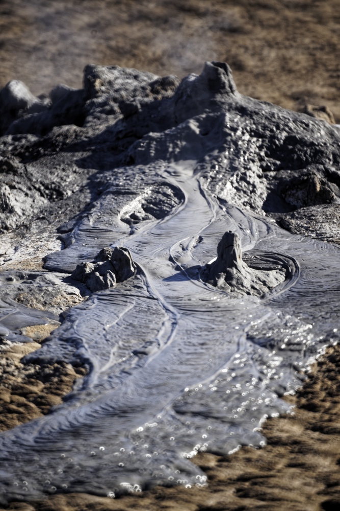 The Changing Climate - Small Volcano  Mud erupts at the mud pots on the shores...