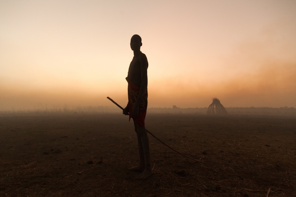  A Mundari man at dusk in Terek...oods and fueling the conflict. 