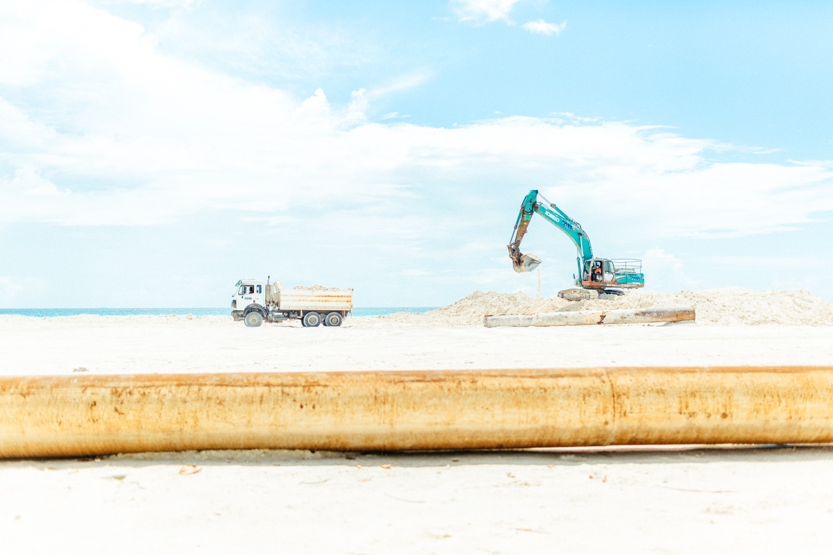 Home - Machinery dredges and relocates sand to build up the...
