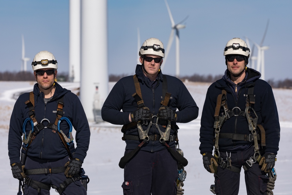 Three wind technicians pose in ... wind farm in upstate New York.