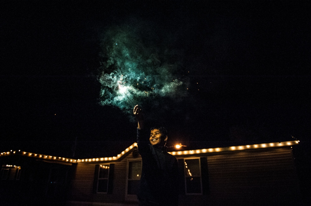  Anirudh Sharma waves a sparkler above his head during a Diwali celebration Saturday night at the Shanthi Mandir in Columbia. The five-day holiday, also known as the &quot;Festival of Lights,&quot; is one of the most important in the Hindu faith. 