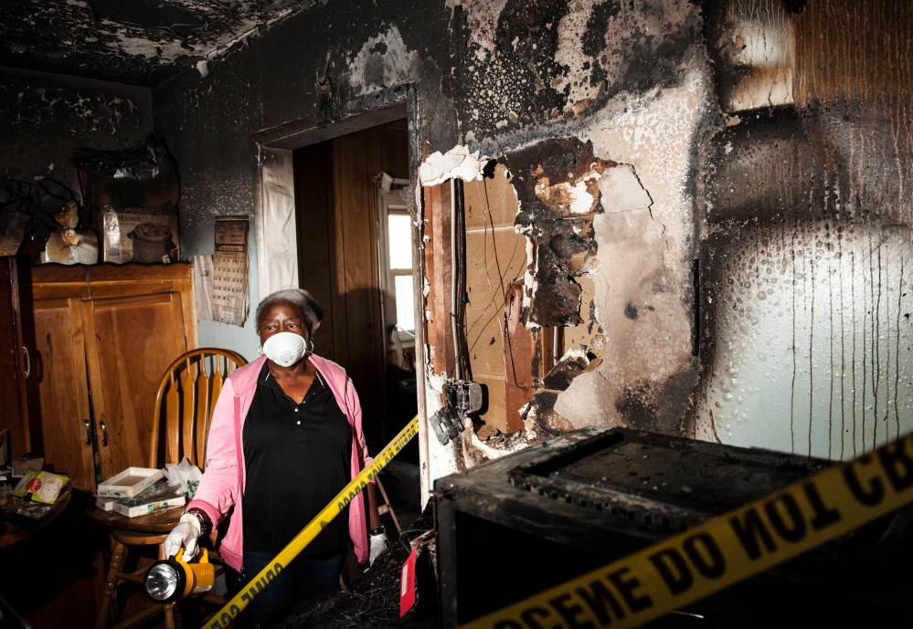  Dottie Mulkey, 74, walks through her damaged kitchen in Santa Ana after a December fire. Mulkey&#39;s homeowner&#39;s insurance had lapsed at the time of the blaze leaving her unable to restore her home. 