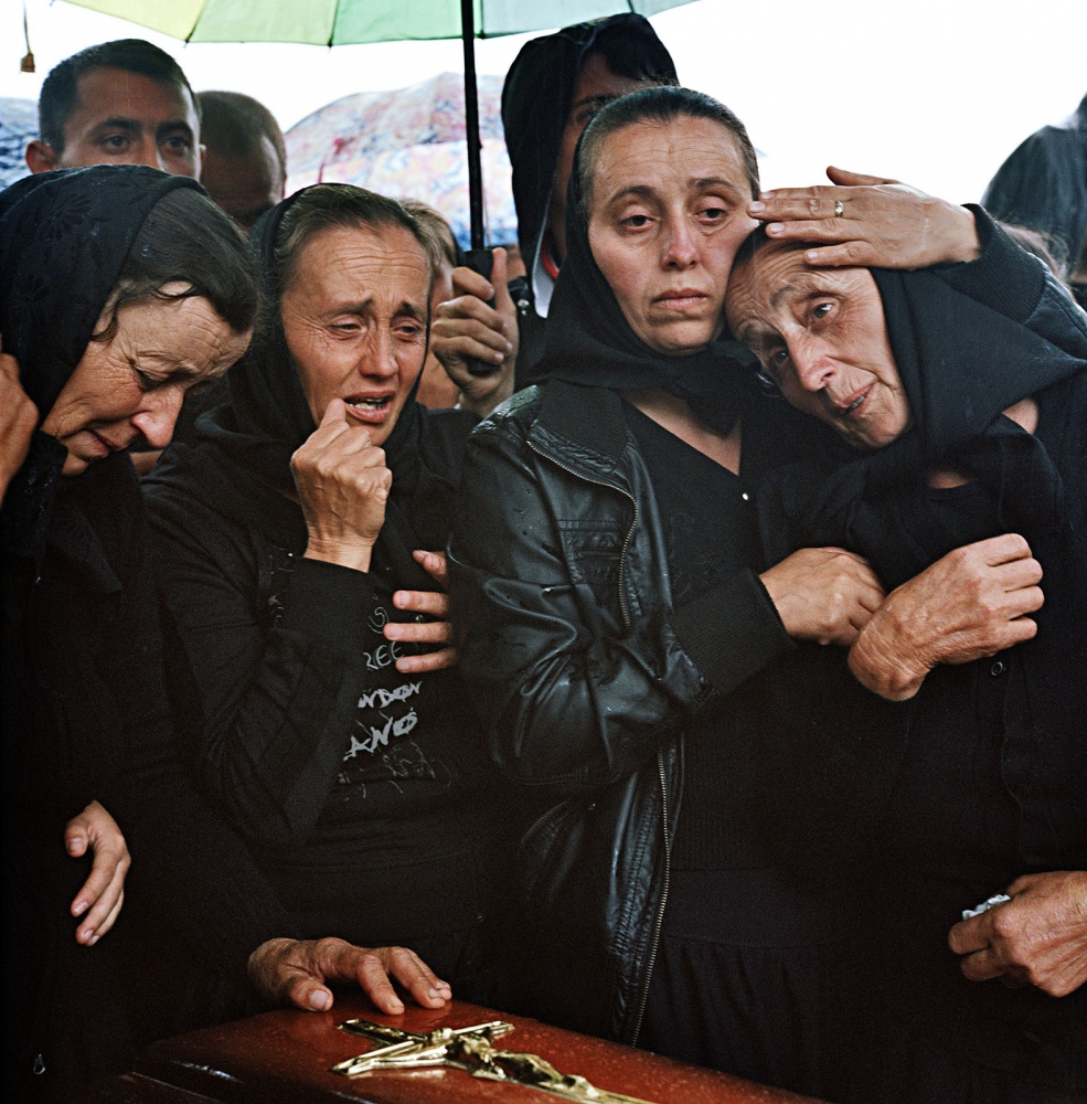 Transylvania: Built on Grass -  Irina Veciunca is comforted at the burial of her...
