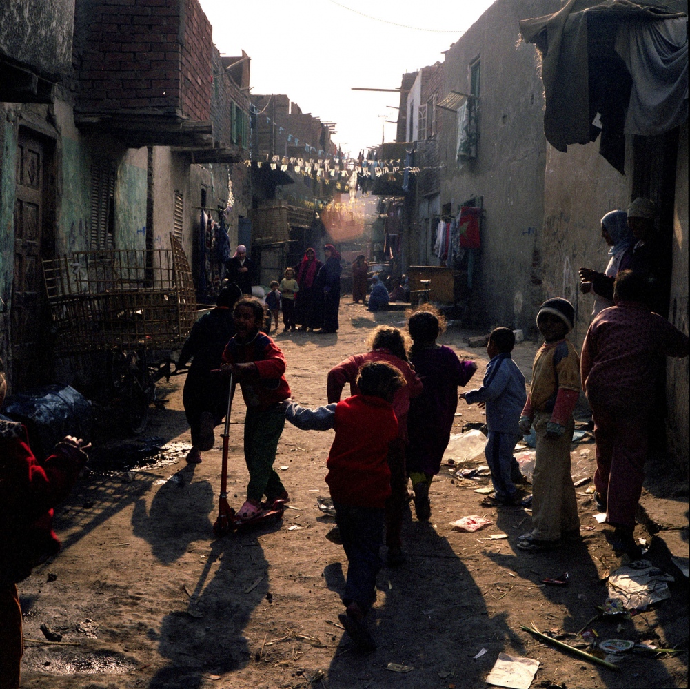 Cairo: Urban Decay -  Children running in the informal neighborhood of Batn...