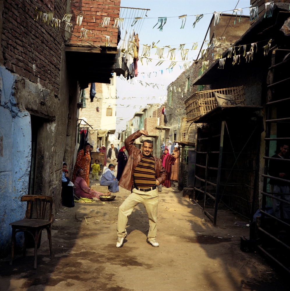 Cairo: Urban Decay -  Man dancing on the street in the informal neighborhood...
