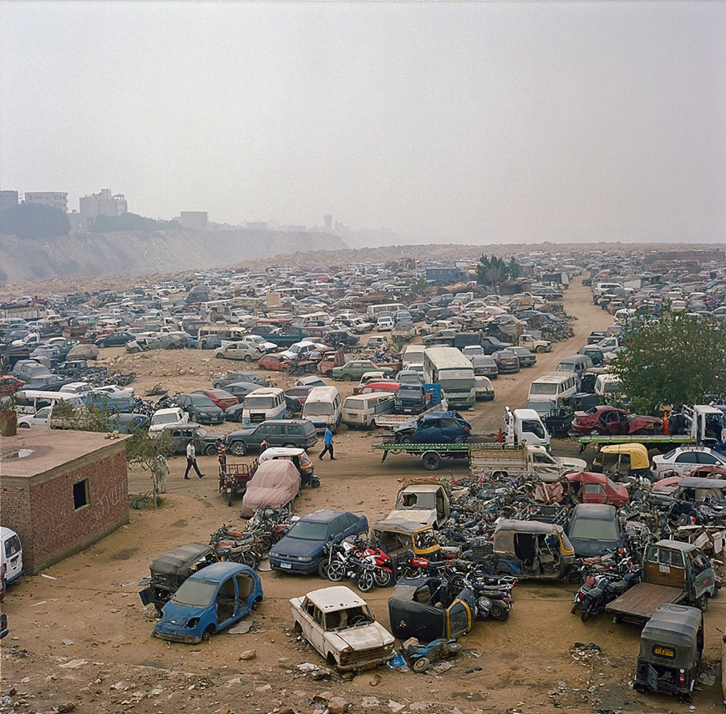 Cairo: Urban Decay -  A scrap yard for discarded cars along the desert road in...
