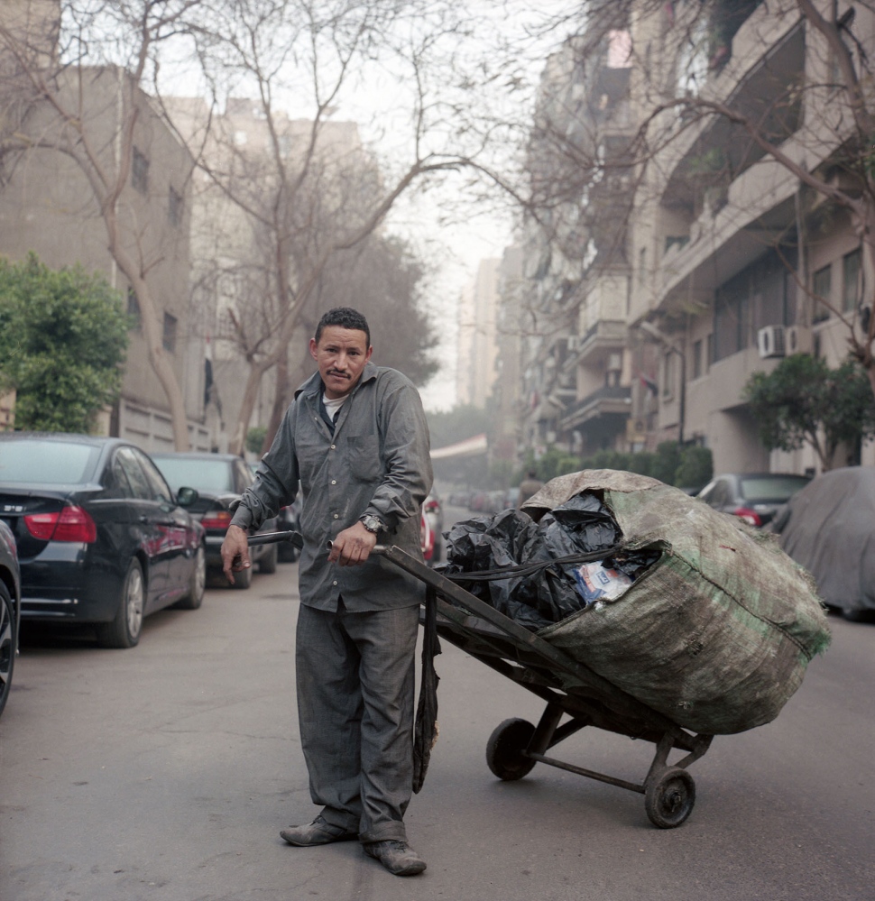 Cairo: Urban Decay -  Seyid, the trash collector picks up garbage during early...