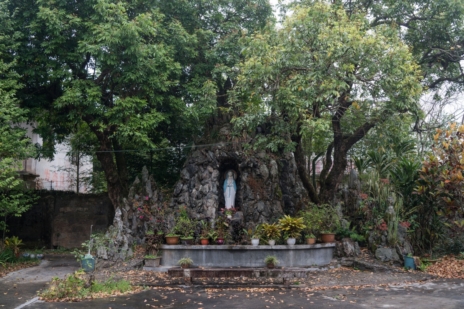 A Rural Chinese Catholic Village - A Mary statue stands in the courtyard of Luotianba Church...