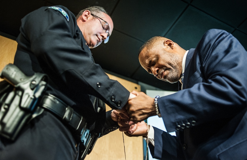  Irvine Police Chief Mike Hamel bows his head in prayer with Pastor Mark Whitlock of Christ Our Redeemer AME Church after tying a thread around each others wrists as a symbol of unity during a &quot;thread ceremony.&quot; The ceremony has held in the aftermath of an attack in Dallas that killed five police officers and multiple black men killed across the country by police. 