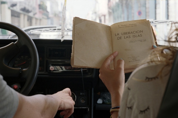 Image from Cheap Knockoffs -  Lisette looking through the book I just bought, Havana,...