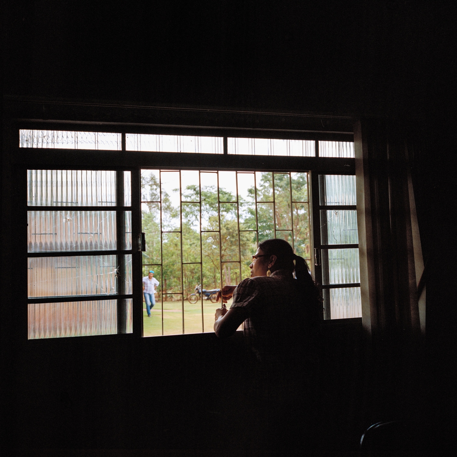 November 28, 2016. Local psychologist Elizeti Moreira looks out the window of health center in the Dourados Guarani-Kai&oacute;wa Reservation in Matto Grosso Du Sul, Brazil. Oliveira committed suicide the previous week and had come to see her for help beforehand, he had spoken about his inability to get work and support his four children, although he had never mentioned thoughts of suicide. He was 39 years old.