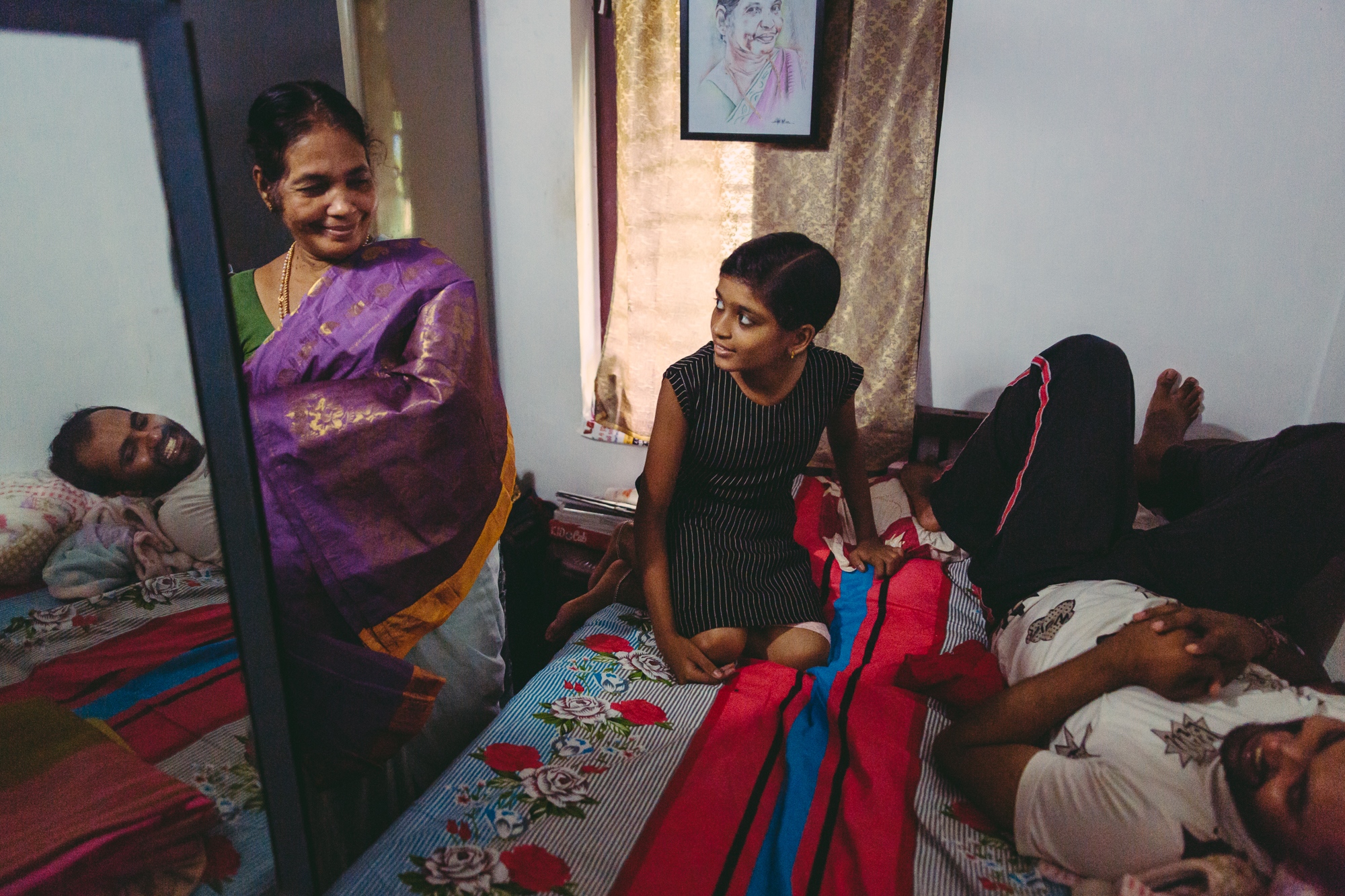  Vatakara, Kerala, INDIA - September 12, 2017: Meenakshi Raghavan &#39;Gurukkhal&#39; (L), 76, shows her Sari collection to her grand-children Lena (C), 14, and Jithin (R), 27. When Meenakshi was a young woman, she owned only four Saris and dreamt of owning a variety, she recalls. Nowadays, she has more Saris than she can count. She always wears a Sari, even when practising Kalaripayattu. 