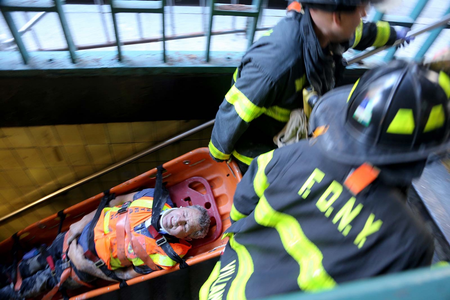  Firefighters rescue an MTA worker who fell on subway tracks while working on repairs at the 57th St. F train station in Midtown on Sunday morning. 