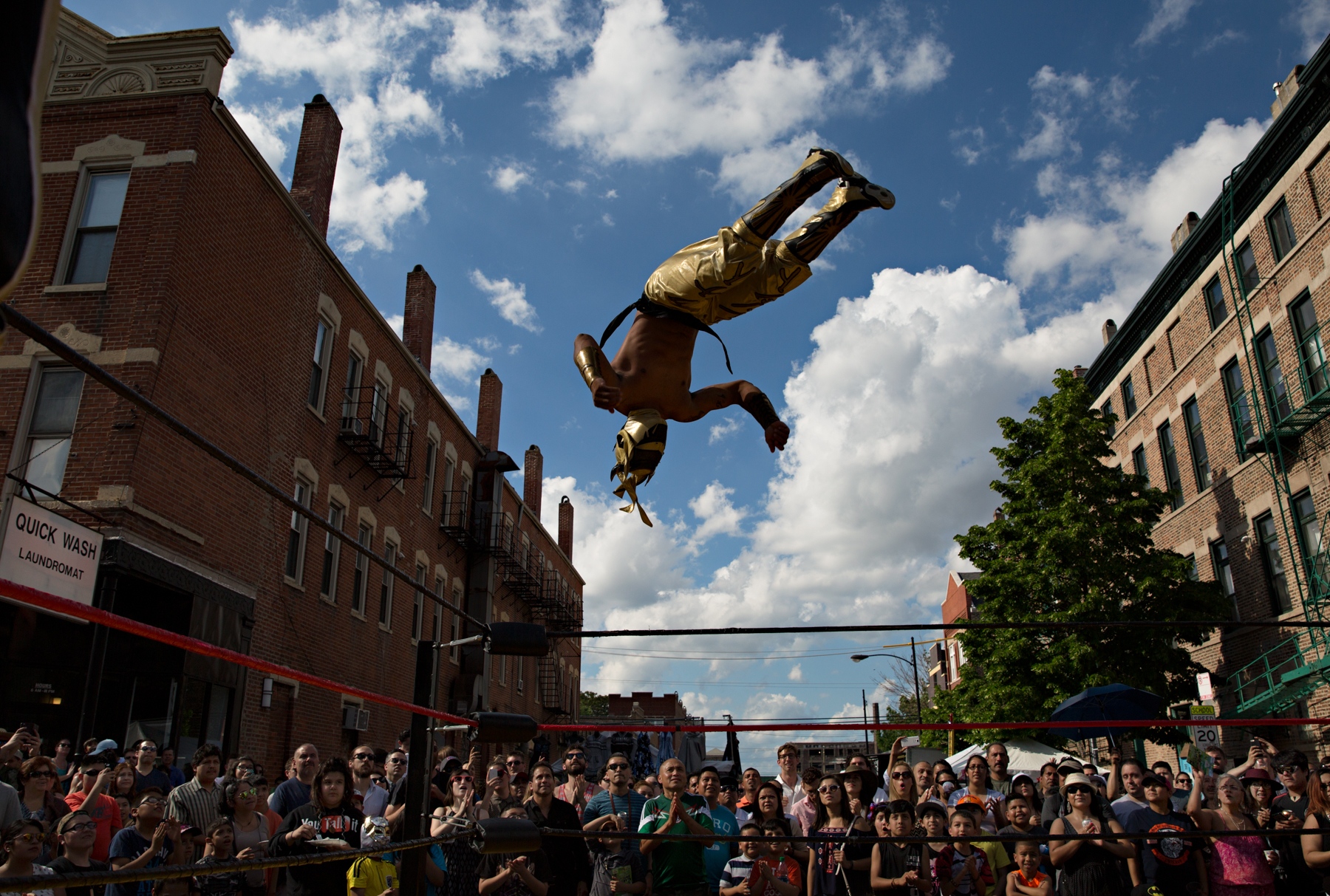  During the Mole de Mayo, a yearly mole sauce competition in the Pilsen neighborhood in Chicago, a luchador demonstrates his high flying aerial jump during a Lucha Libre show. 