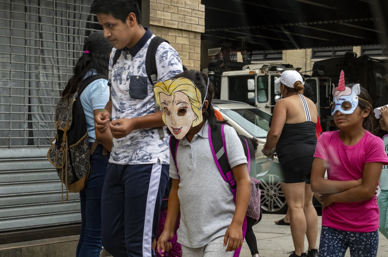  Migrant Children leaving the Cayuga Center at 1916 Park Ave in East Harlem wear masks to protect their identity, Manhattan, NY June 22, 2018(Kevin C Downs/Agence Cosmos) 