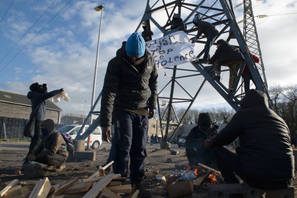  During the visit of French President Emmanuel Macron to Calais homeless migrants living in the Jungle in Calais hung banners and published a joint statement on Facebook to denounce police violence towards them, ask for the end of the Dublin Act and for borders to be open. Calais, France - January 16, 2018.   