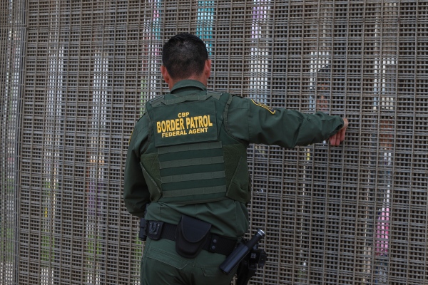Friendship Park  - Border Patrol agent Rocha speaking with visitors in Tijuana.