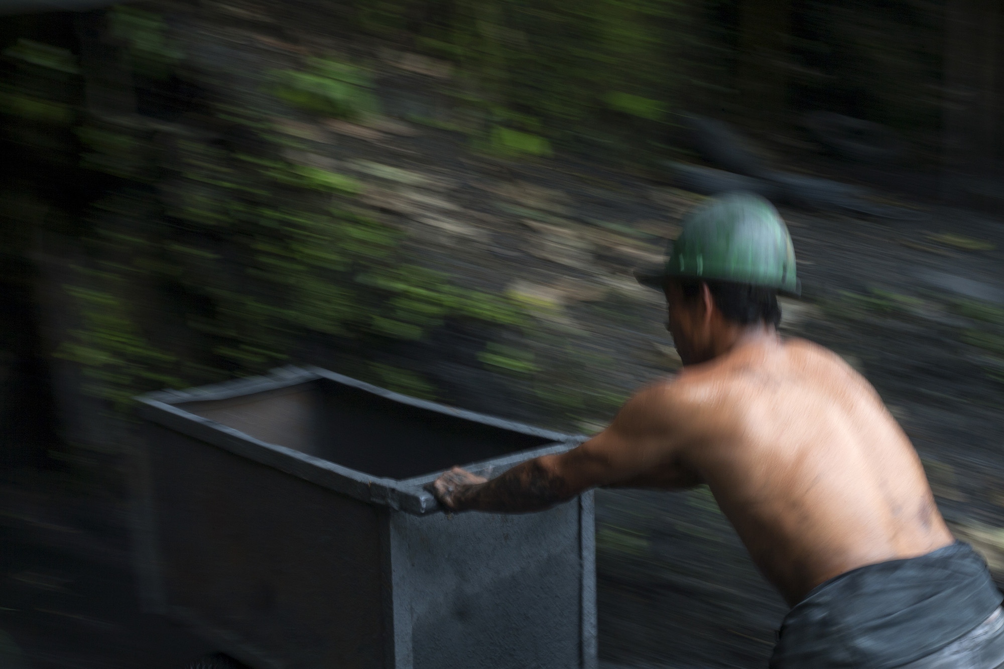 A miner enters with a cart to transport land to an emerald mine in the Muzo region, Boyac&aacute;, Colombia. The vast majority of the work in the mines is done with human strength, hand tools, dynamite and will.