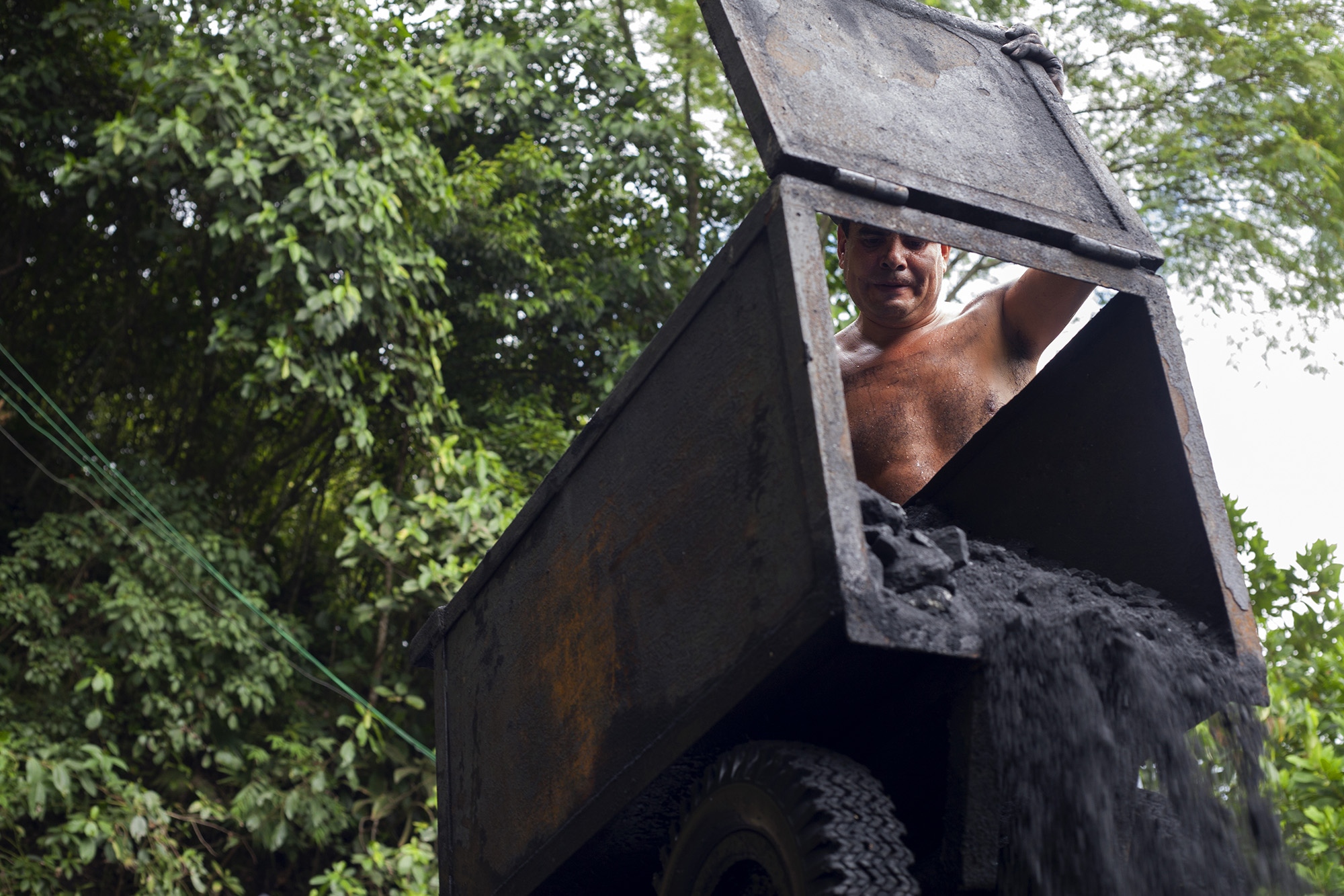 Muzo - A miner works with a cart to transport soil to an emerald...