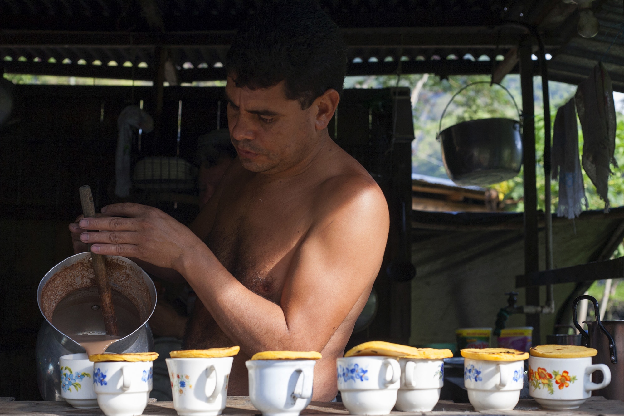 Muzo - A man sells breakfasts composed of arepas and chocolate...