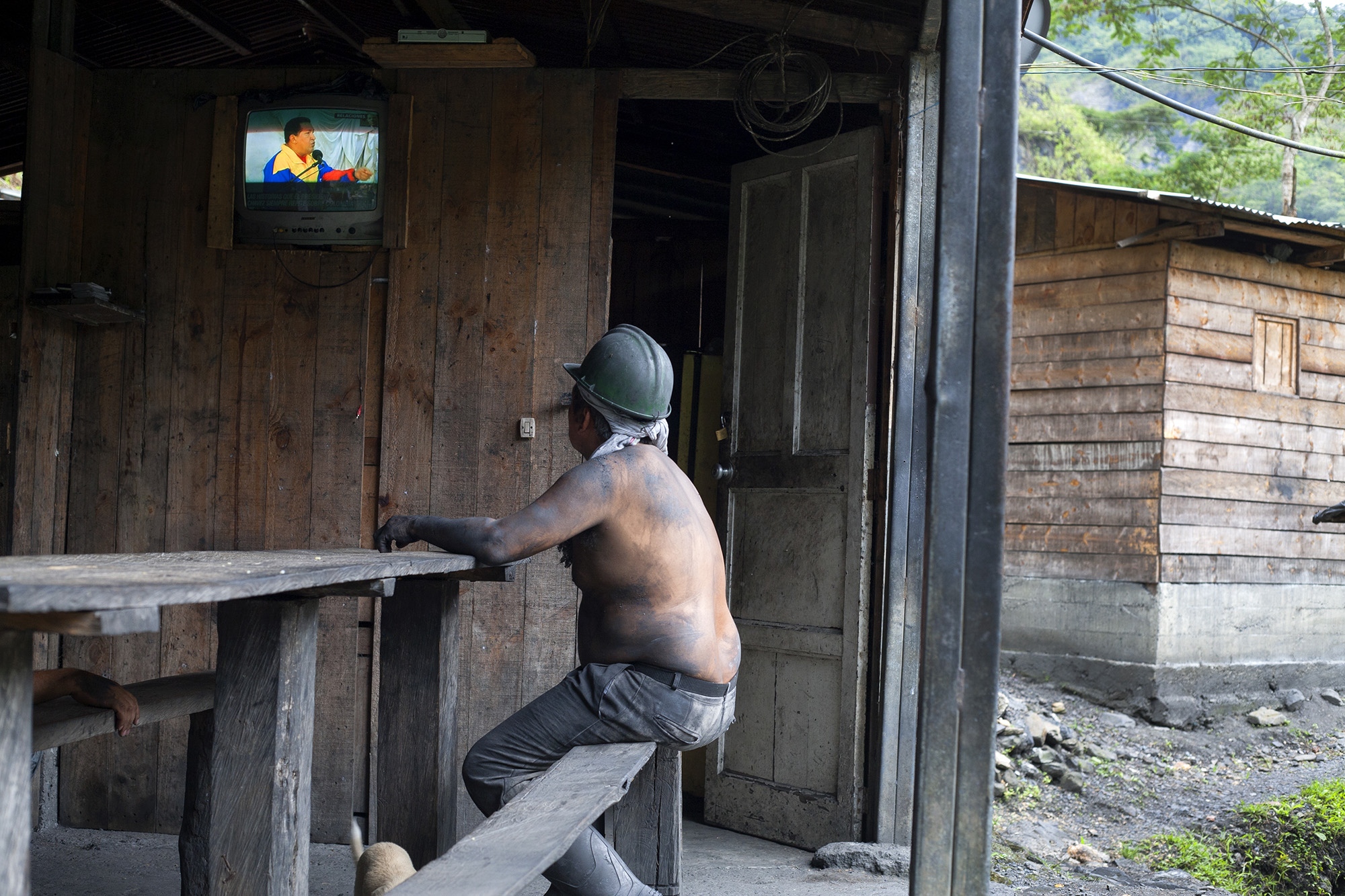 Muzo - A miner watches the national television of Colombia,...