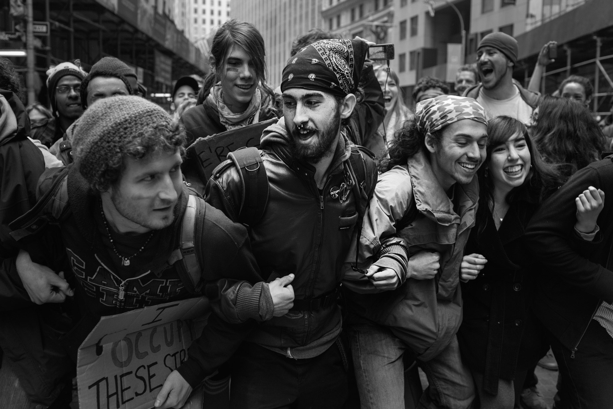  OWS protestors link arms to avoid people being singled out and arrested during a demonstration. 