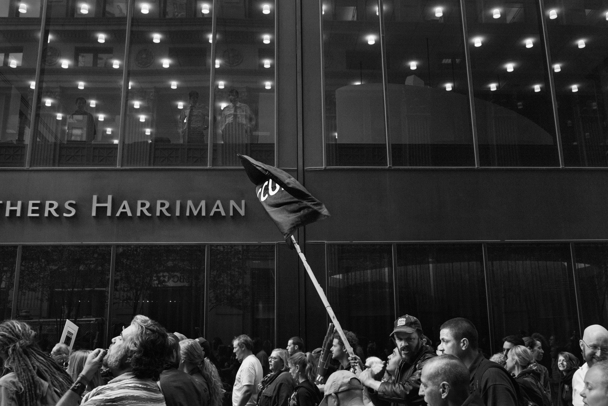 Occupy Wall Street -  OWS protestors march past a Brown Brothers Harriman, an...