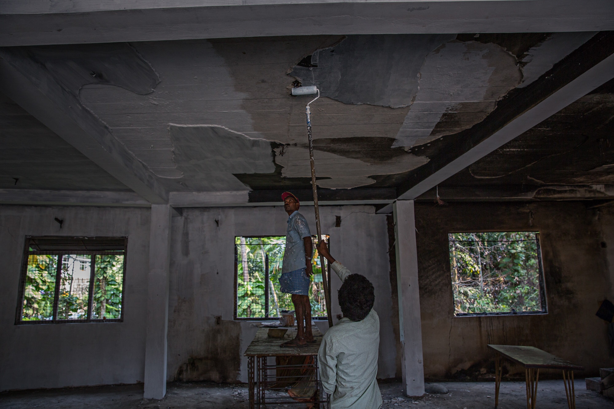 Sri Lanka Religious Violence: Buzzfeed News -  Workers repaint a ruined building at Eighth Mile Post,...