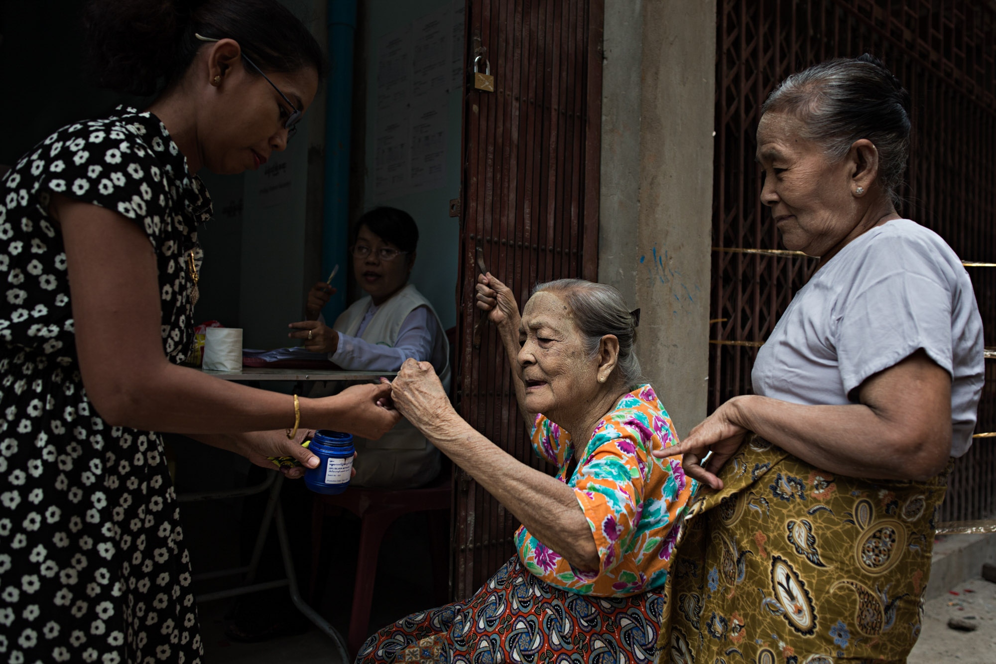 Myanmar Election: Al Jazeera - An elderly woman dips her finger into purple ink,...