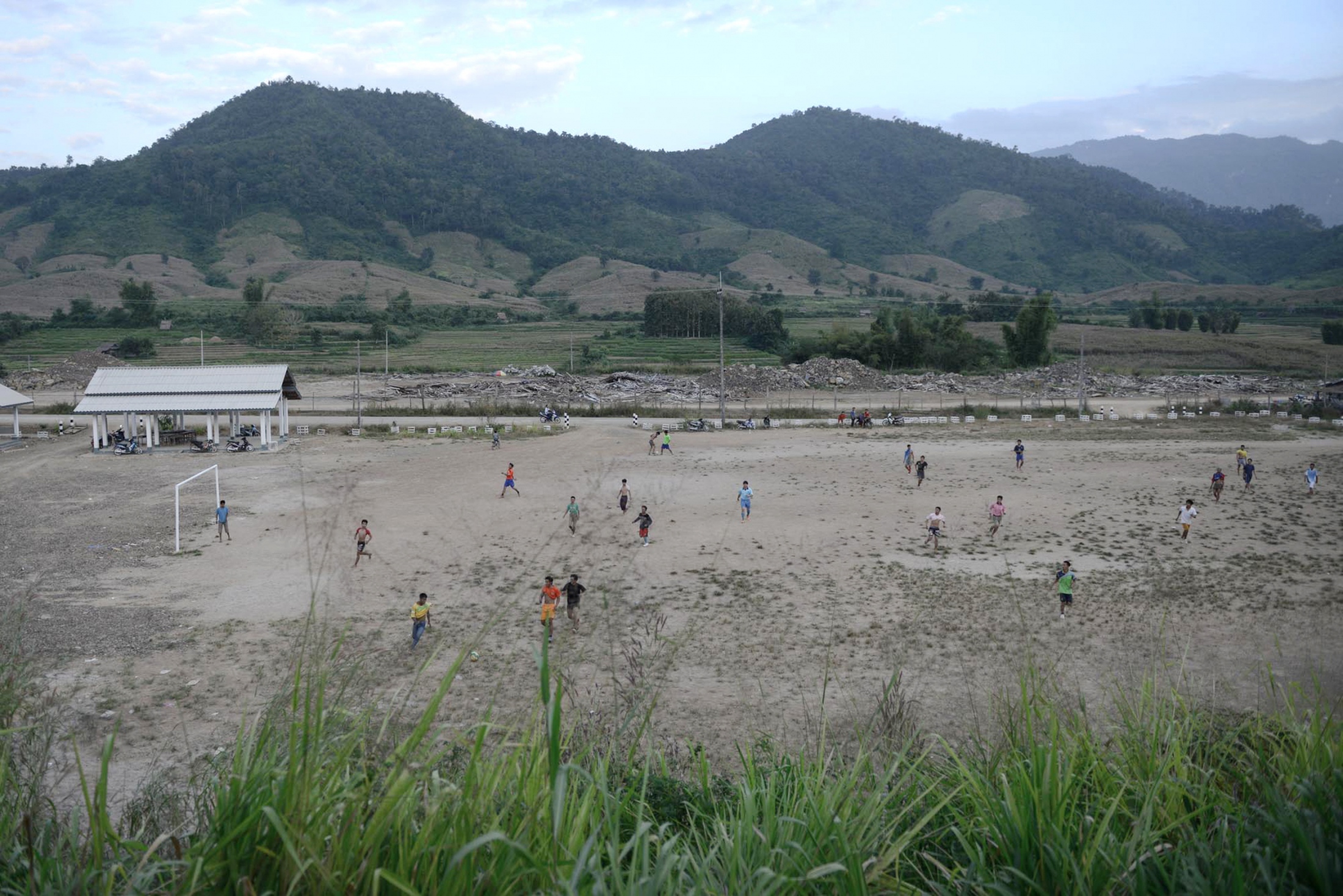 Damming The Mekong River - A football field at the new resettlement site.