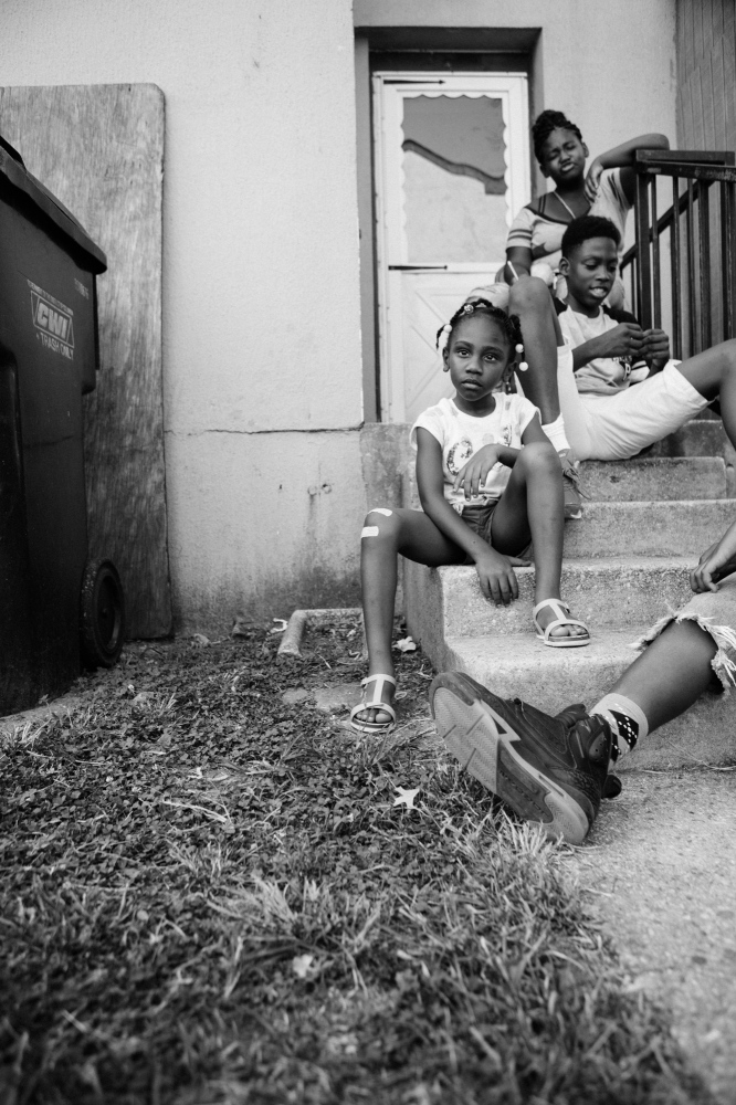 Barry Farm: Coming of age in a gentrifying city -  Bejon Summers, 5, plays on the porch with her siblings...