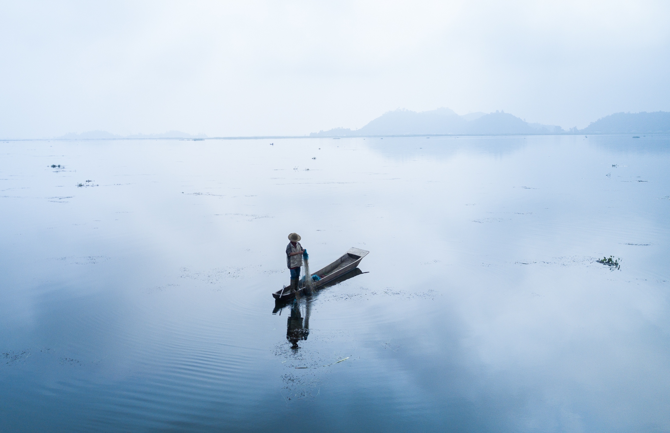 Where the Islands Float -  A Meitie fisherman fishes in Loktak Lake, Manipur. The...