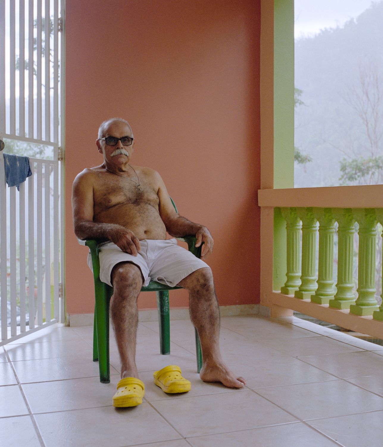 La Isla Del Encanto; Borikén - Uncle Coco sits on his porch and takes in the smells and...