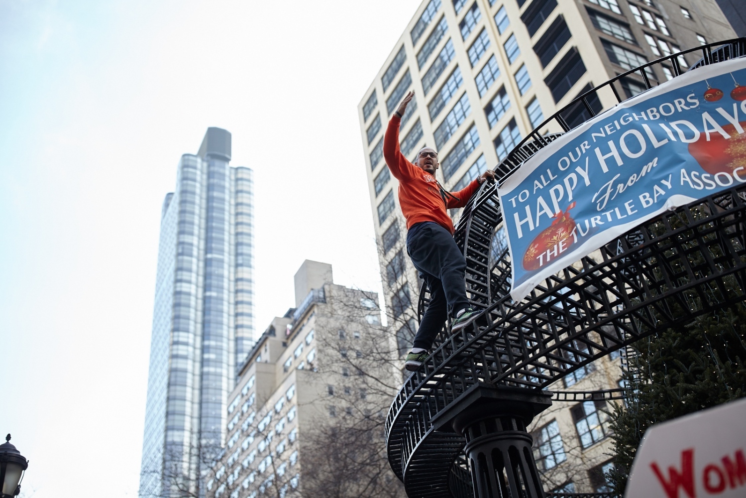 A demonstrator climbs up a meta...ew York, U.S. January 21, 2017.