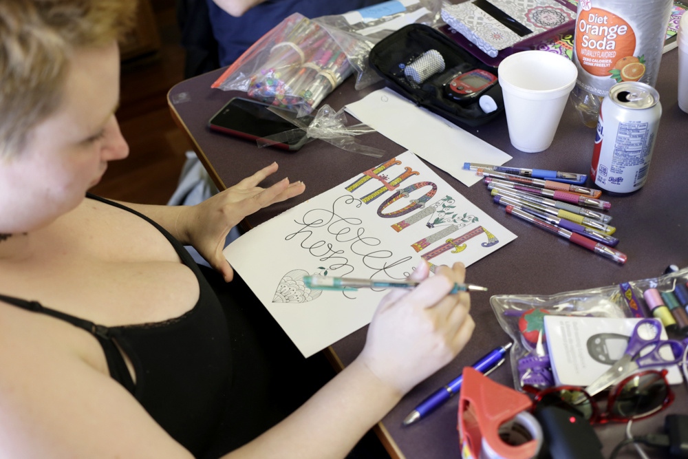 Sufficient To The Day -  Angel Davis colors a page out of her coloring book at...