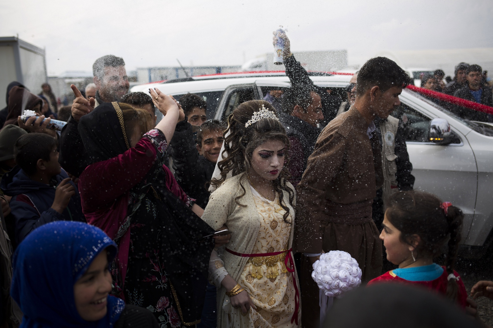 Hussein Zeino Danoon (25) and &nbsp;Shahad Ahmed Abed (16) arrive at the Khazer camp for displaced from Mosul for their wedding. The legal age for marriage in Iraq is 18, or 15 with parental permission. The two celebrated their wedding less than a month after fleeing the fighting in Mosul.