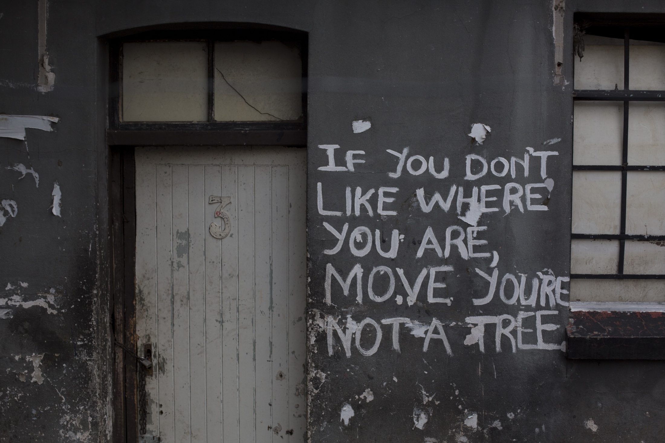 Squatters City  - A message covers an occupied building complex. April 9,...