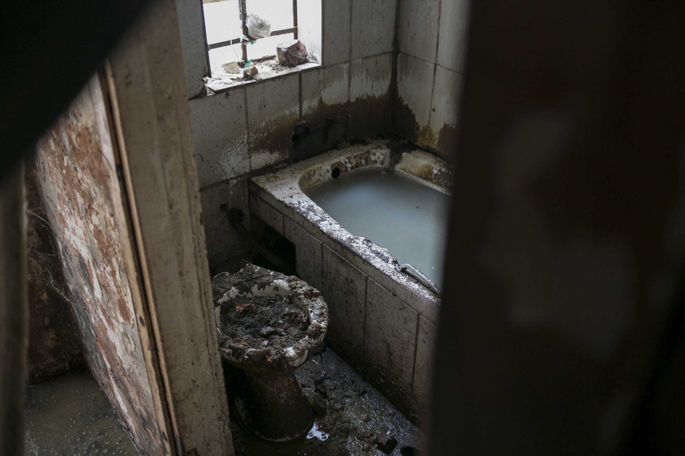 Squatters City  - A toilet is overflowed with feces inside an occupied...