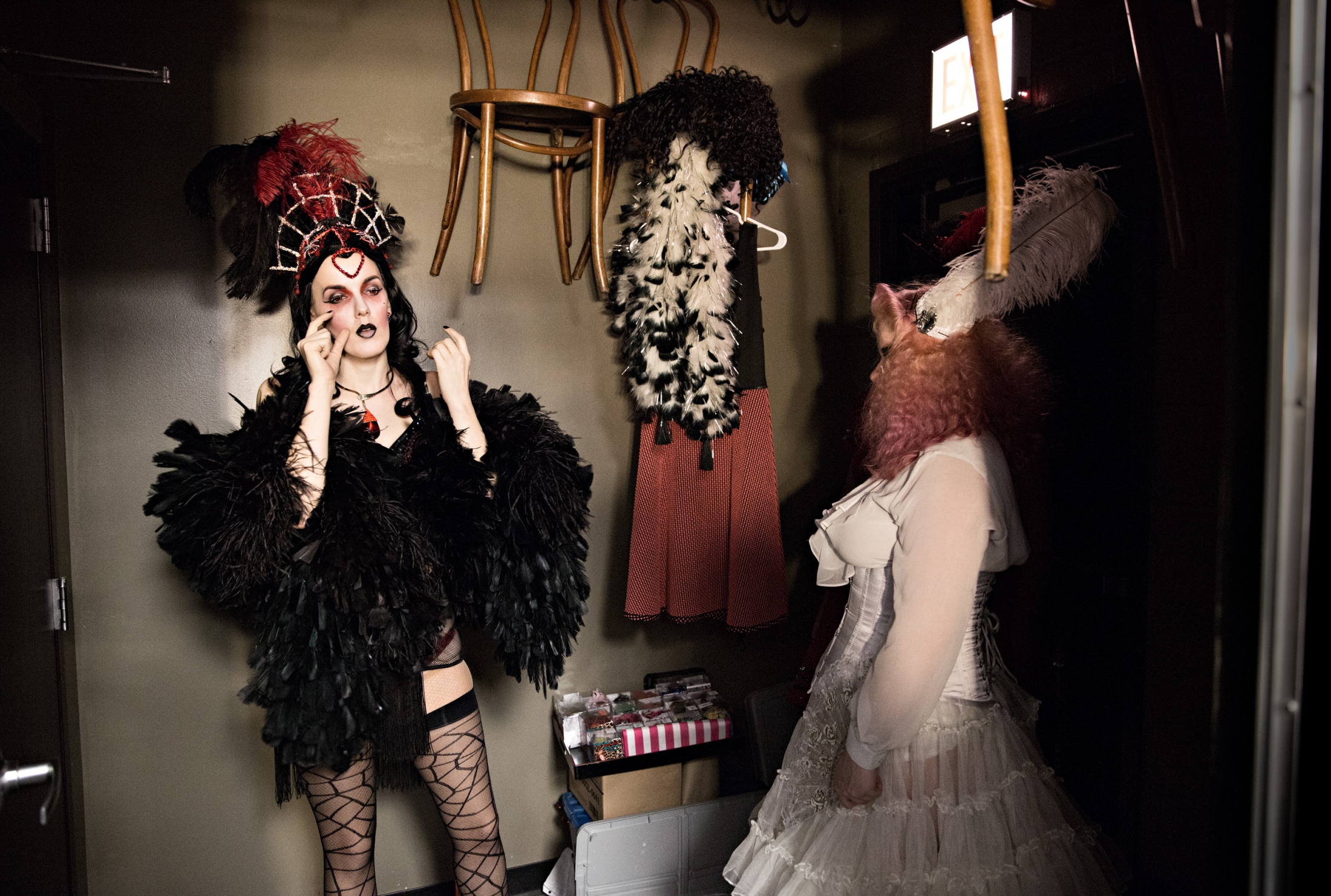 Red Hot Annie and Gin Fizz chat backstage during a show. Vaudezilla performers chat to reduce the performance anxiety that can build up during the wait between acts and waiting to be called to the stage.